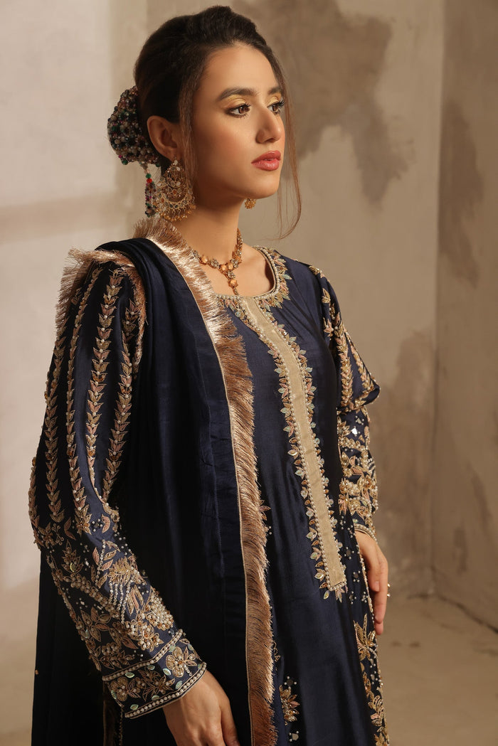 Karigur Dania — full-length navy bridal suit with wide-leg silk pants and a gold-tissue-bordered dupatta.