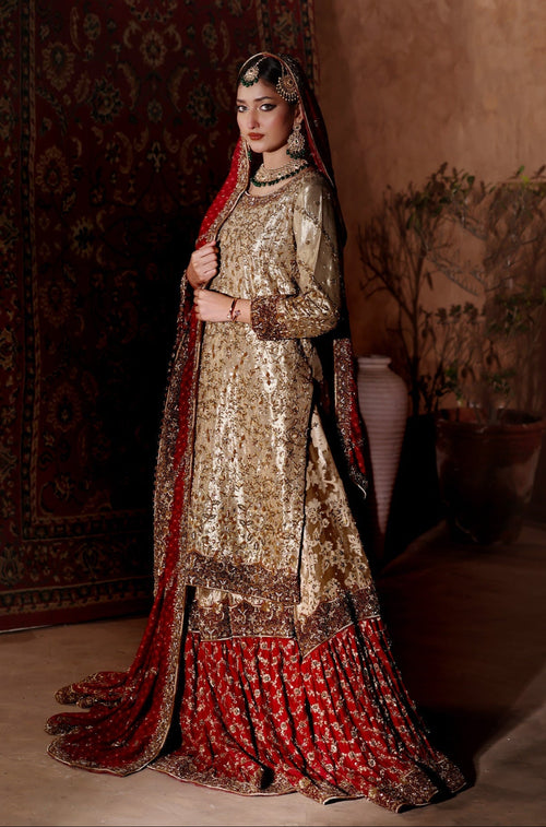 Model in a champagne-gold zardozi kameez and deep red gharara with matching red border dupatta by Karigur Bridal