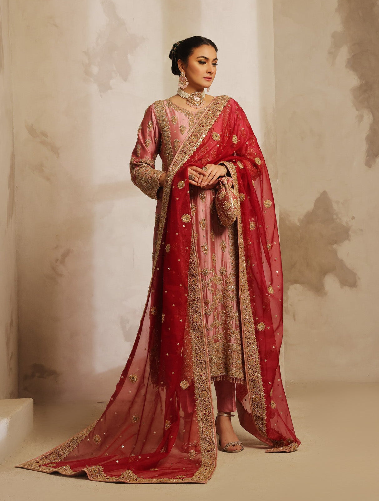Karigur Nayira rose-pink suit with embellished full sleeves and a richly embroidered contrast dupatta.