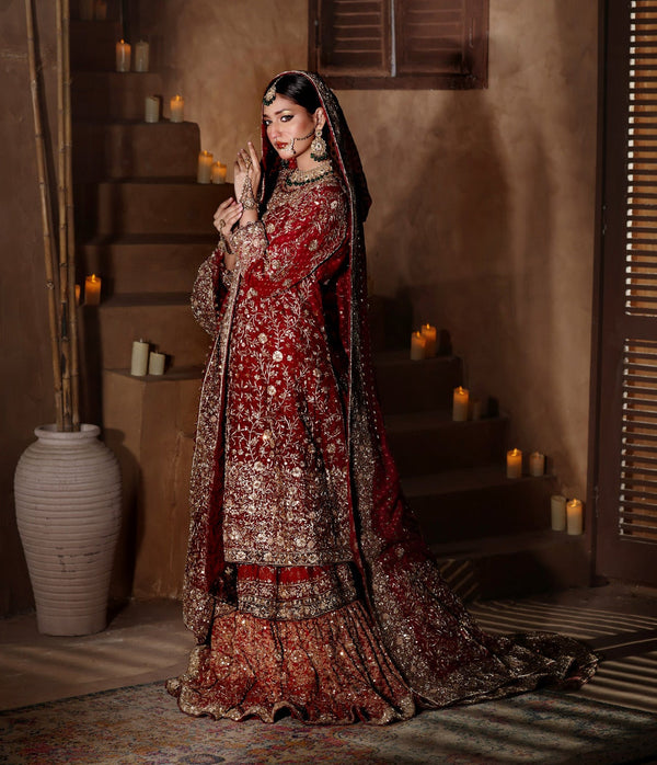 Bride in a deep red bridal kameez with gold zardozi floral embroidery by Karigur Bridal