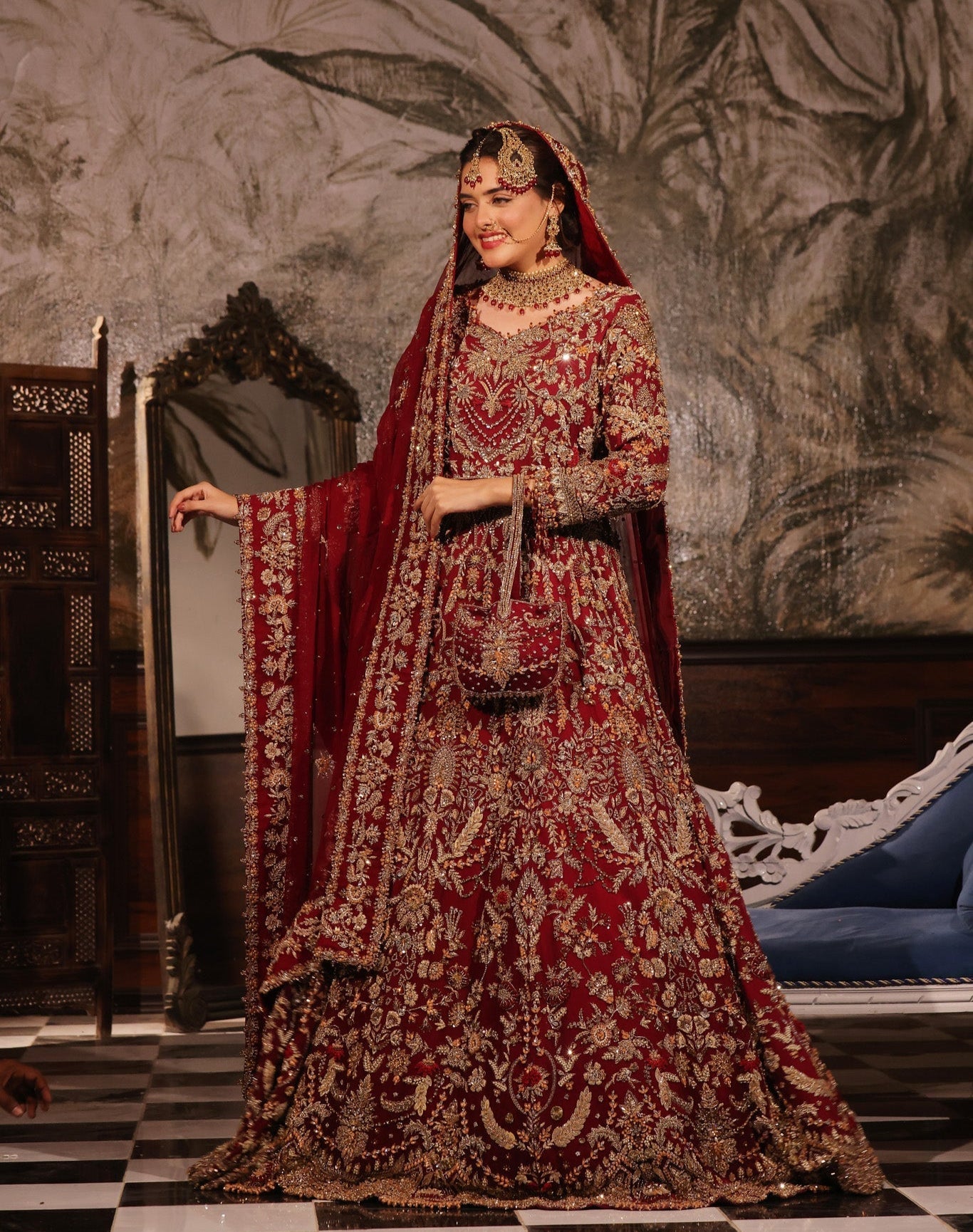 Karigur Ruhani — ruby-red pure-chiffon bridal gown and lehenga with heavy gold zardozi and a head-draped dupatta, front bridal view.