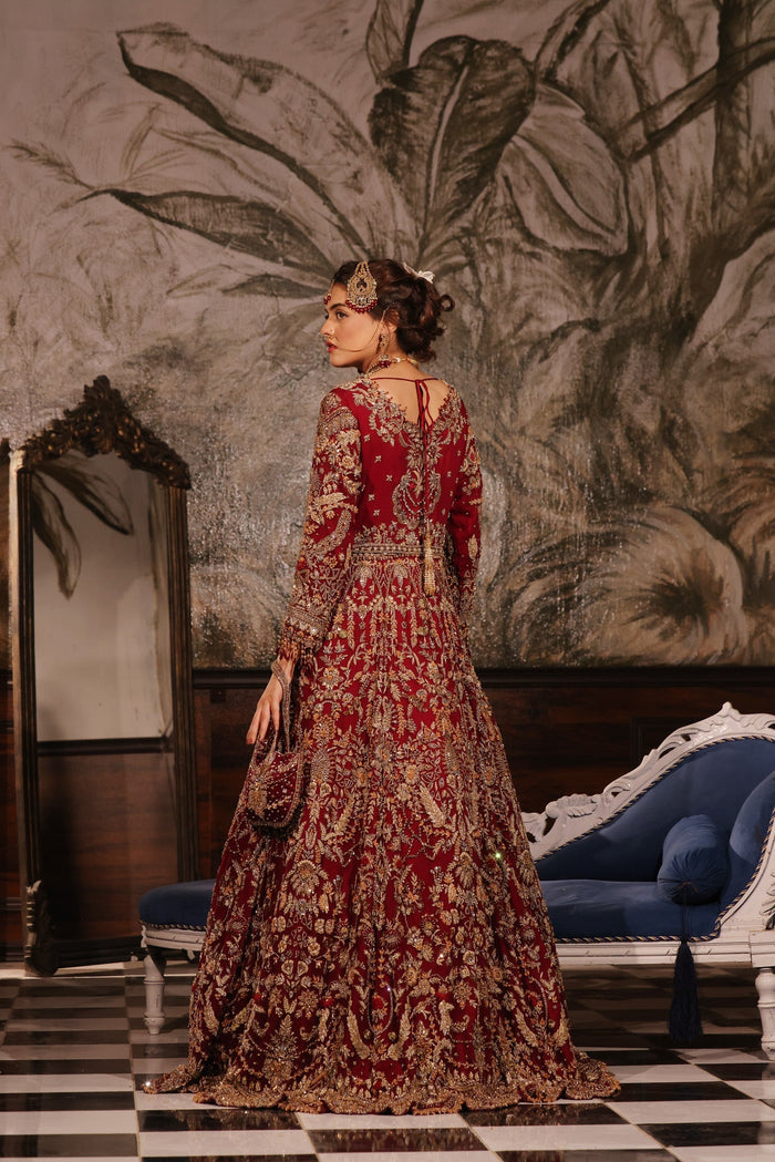 Karigur Ruhani ruby-red fit-and-flare bridal gown over a chiffon lehenga with an embellished belt.