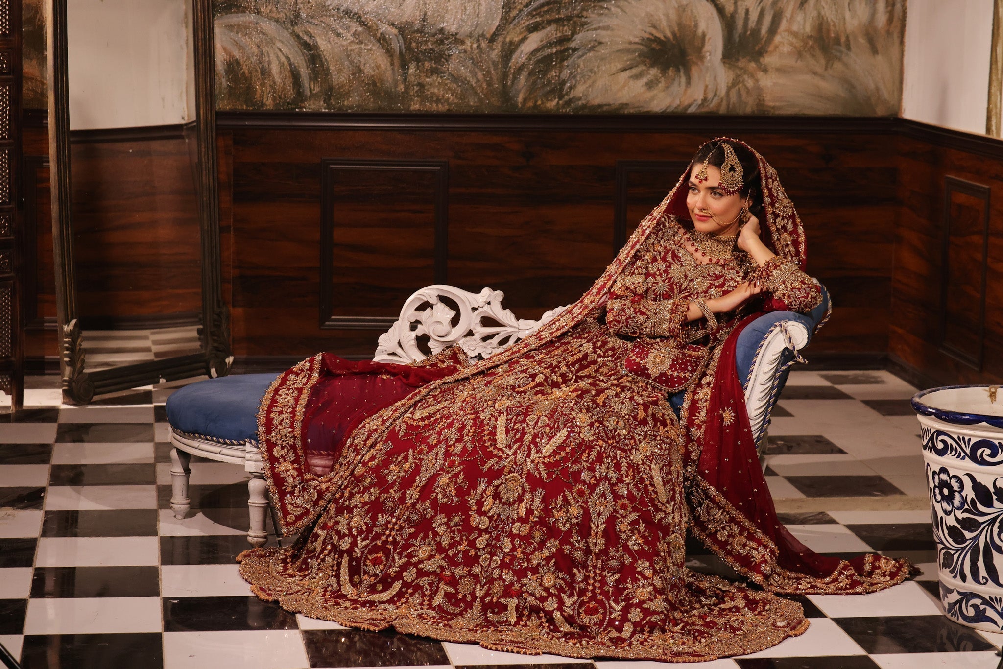 Karigur Ruhani red chiffon bridal gown and lehenga, full bridal styling with a potli bag.
