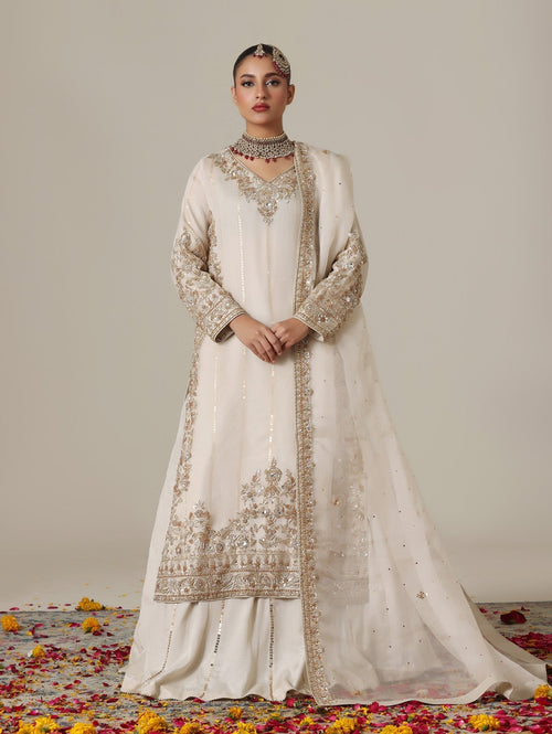 Ivory raw silk front open bridal jacket over a lehenga with pale gold dabka yoke by Karigur Bridal