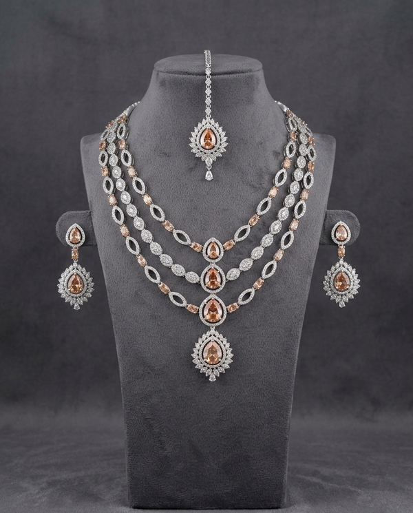 Three-layer silver-tone necklace with amber pear-cut stones, earrings and tikka by Karigur Bridal