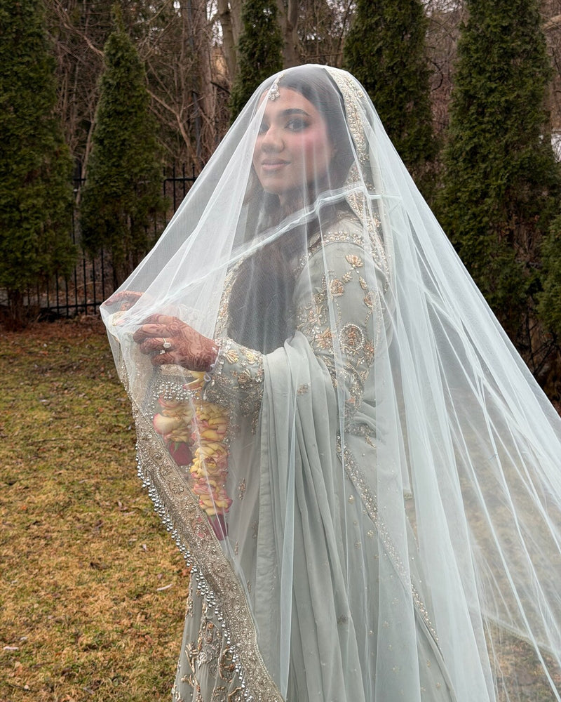 Bride in a pastel ice-blue Nikkah outfit with embroidered veil, by Karigur, the GTA
