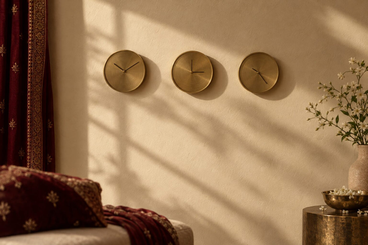 Three brass wall clocks showing different times