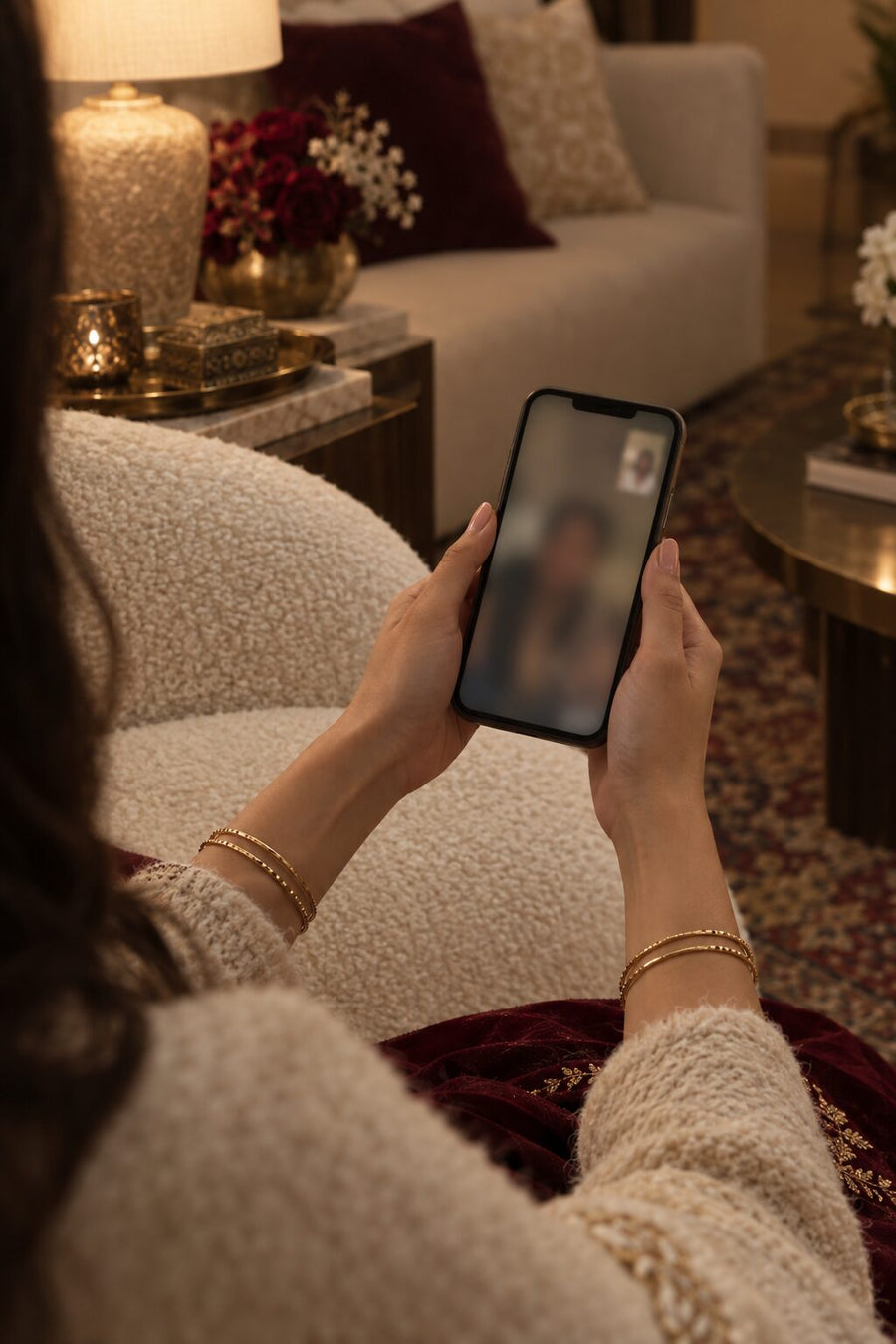 Hands holding a phone during a virtual bridal consultation